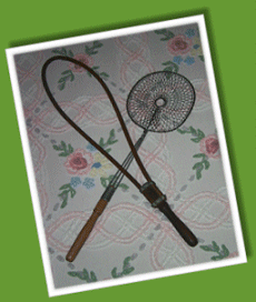 A rattan hoop carpet beater with a turned wood handle & The Perfect Dust Beater - Spring Beater Mfg. Co. - Buffalo, New York 